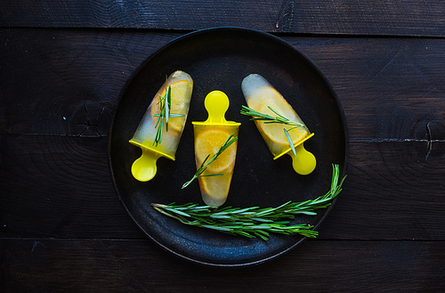 Summer dessert with lemon and mint on rustic wooden background with copyspace