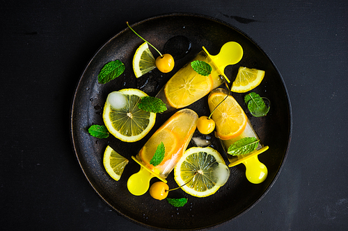 Summer dessert with lemon and mint on rustic wooden background with copyspace