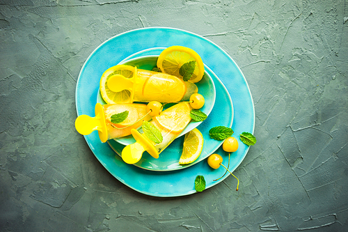 Summer dessert with lemon and mint on rustic wooden background with copyspace