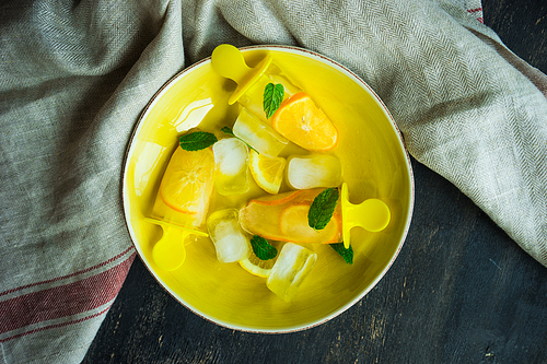 Summer dessert with lemon and mint on rustic wooden background with copyspace