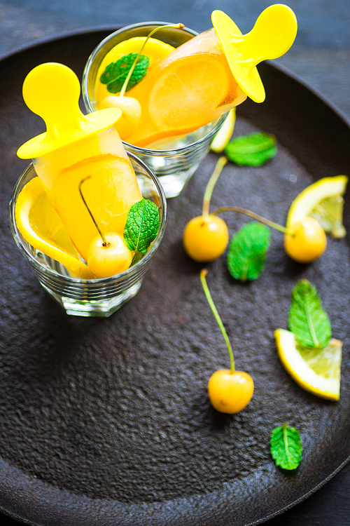 Summer dessert with lemon and mint on rustic wooden background with copyspace