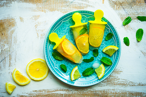 Summer dessert with lemon and mint on rustic wooden background with copyspace