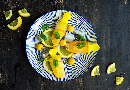 Summer dessert with lemon and mint on rustic wooden background with copyspace