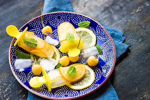 Summer dessert with lemon and mint on rustic wooden background with copyspace