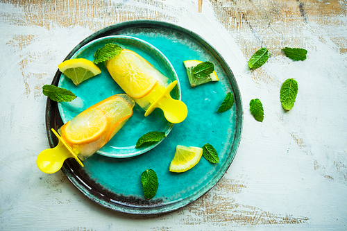 Summer dessert with lemon and mint on rustic wooden background with copyspace