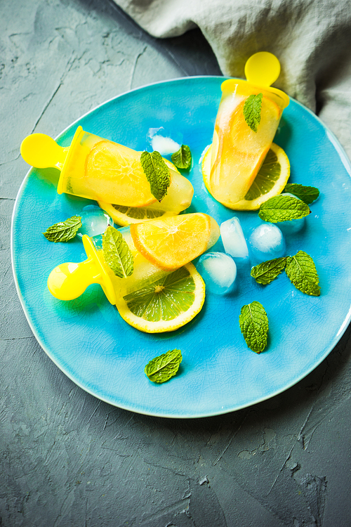 Summer dessert with lemon and mint on rustic wooden background with copyspace