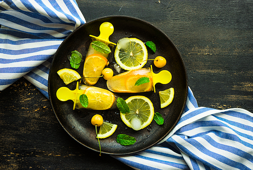 Summer dessert with lemon and mint on rustic wooden background with copyspace