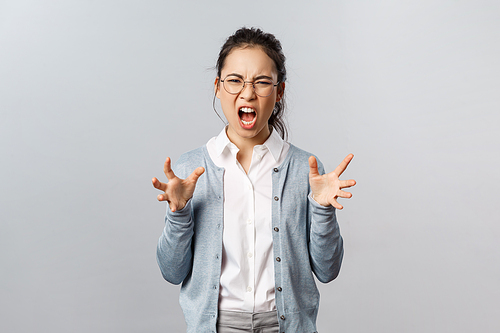 Emotions, people and lifestyle concept. Angry pissed-off, sick and tired asian woman in glasses shouting and clench hands into fists agressive, hate someone shouting with anger and rage.