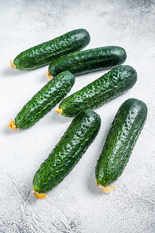 Organic Green Cucumbers on a kitchen table. White background. Top view.