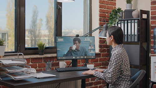 Business woman using video call meeting to talk to colleague in office. Entrepreneur chatting with man on online video conference about project planning and strategy. Online conference