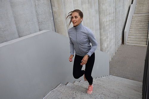 Runner athlete running on stairs. Woman fitness is jogging oudoors.