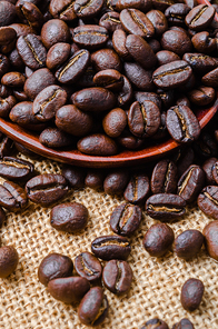 Coffee beans on sack background.