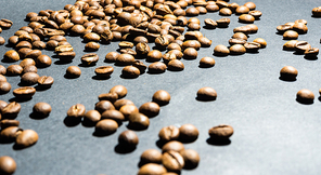heap of coffee beans on black background.