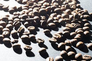 Pile coffee beans isolated on black background and texture, top view