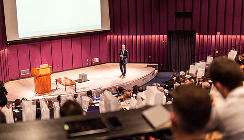 Speaker Giving a Talk at Business Meeting. Audience in the conference hall. Business and Entrepreneurship concept.