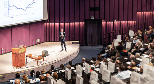 Speaker Giving a Talk at Business Meeting. Audience in the conference hall. Business and Entrepreneurship concept.