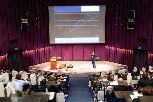 Speaker Giving a Talk at Business Meeting. Audience in the conference hall. Business and Entrepreneurship concept.