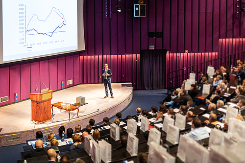 Speaker Giving a Talk at Business Meeting. Audience in the conference hall. Business and Entrepreneurship concept.