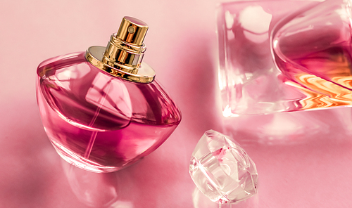 Perfumery, spa and branding concept - Pink perfume bottle on glossy background, sweet floral scent, glamour fragrance and eau de parfum as holiday gift and luxury beauty cosmetics brand design