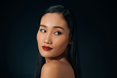 Portrait of attractive Asian woman isolated over balck background