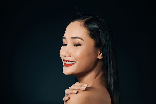 Portrait of attractive Asian woman isolated over balck background