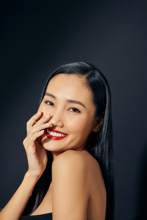 Asian beautiful woman with red lipstick isolated on black background. copyspace.