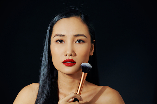 Young asian woman doing make-up