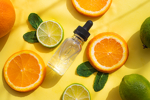 Hyaluronic acid and citrus fruits . Cosmetic procedures. Healthy skin. Skin care. Citrus oil. Yellow background. Copy space. Article about care cosmetics