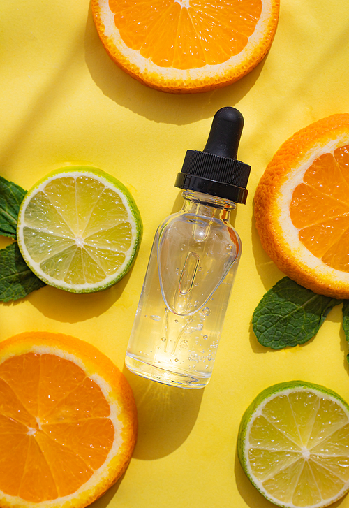 Hyaluronic acid and citrus fruits . Cosmetic procedures. Healthy skin. Skin care. Citrus oil. Yellow background. Copy space. Article about care cosmetics