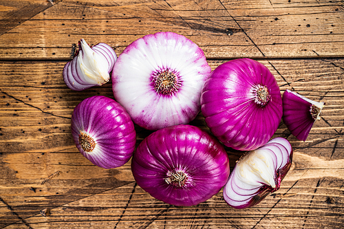 Sweet red onion on a wooden table. Wooden background. Top View.