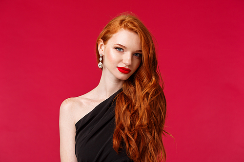 Close-up portrait of attractive sensual and flirty young woman with red lipstick, capturing gaze, wear earrings and black dress, look camera sassy knows what she wants, red background.