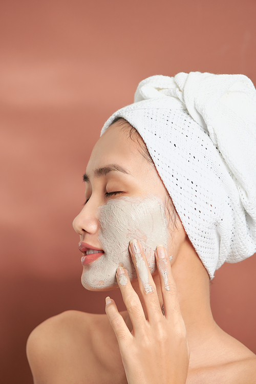 Young Pretty Asian Woman With Cosmetic Mask. Spa, beauty concept.