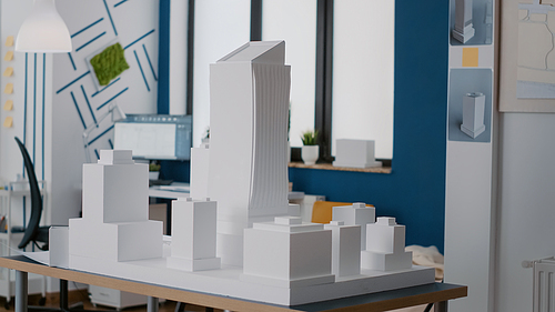 Nobody in architectural office with maquette to design building model and construction. Empty space with architecture tools used to plan urban layout and structure for development.