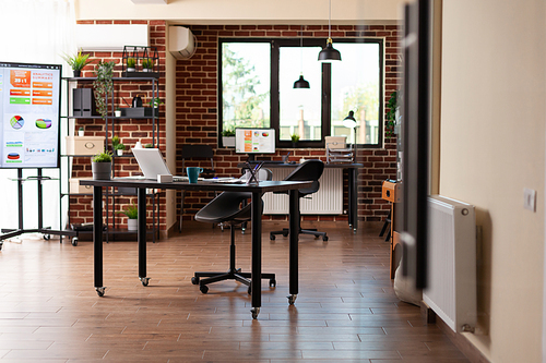 Nobody in startup office with desks and technology, used to plan business project. Empty space with modern equipment and furniture, decorations for financial meeting in boardroom.