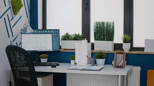 Close up of monitor with digital blueprints plans on desk for architecture design of building layout. Computer with sketch print to measure urban structure for construction site in office.