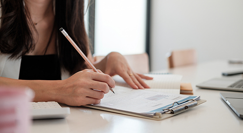 Business woman working in finance and accounting Analyze financial budget at home office.