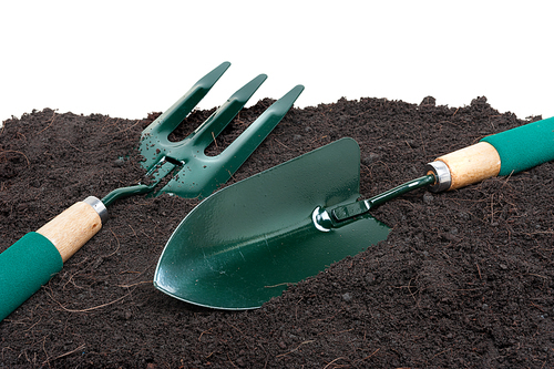 gardening tools on black soil