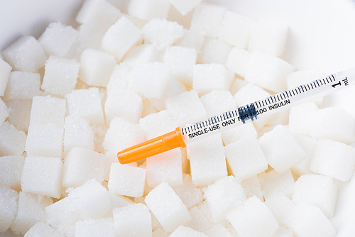 Sugar cube texture background sweet food ingredient and syringe, studio shot health high blood risk of diabetes and calorie intake concept