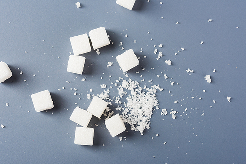 White sugar cube sweet food ingredient and broken, studio shot isolated on a gray background, Minimal health high blood risk of diabetes and calorie intake concept