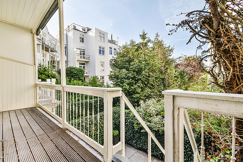 Attractive long narrow balcony with wooden handrails