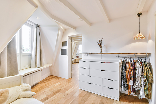 Bright room with a beautiful design with a white chest of drawers