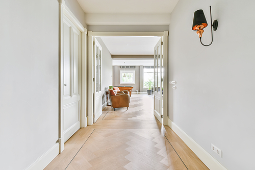 Long stunning hallway with wood flooring and white walls