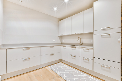 Bright kitchen with a white kitchen set on two walls