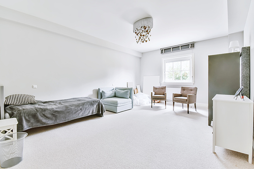 Stunning bedroom with a single bed and plenty of armchairs