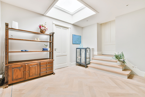 Bright room with a wooden wardrobe and a window on the ceiling