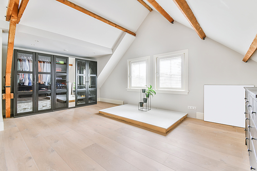 A bright room with a full-length black wardrobe