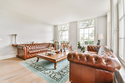 Luxurious living room with soft sofa and armchairs