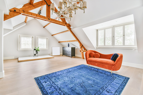 Cozy bright room with a bright red sofa in the middle