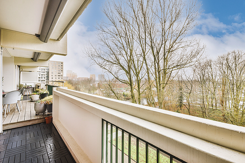 Modern balcony design, coffee table with chairs, green plants and glass railings