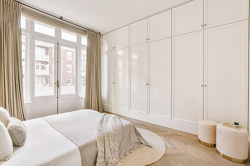 The interior of a bedroom with a large bed and bright designs in a modern house